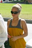 Hayden Panettiere in short yellow dress walks her puppies